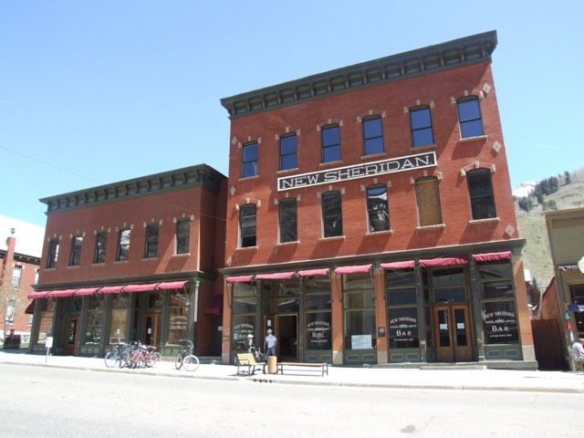 The historic red-brick New Sheridan Hotel and its Chop House on Colorado Avenue