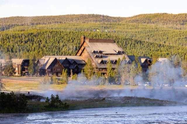 First light on the historic log facade of the Old Faithful Inn