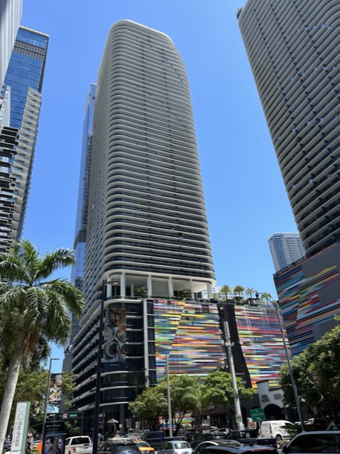 The SLS LUX Brickell tower's curved white balconies rising over downtown Miami