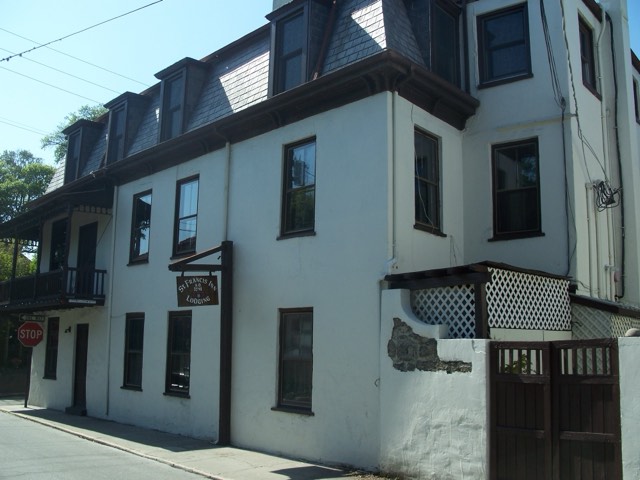 The St. Francis Inn — a 1791 coquina-and-stucco building with a mansard roof and hanging 'St. Francis Inn Lodging' sign in St. Augustine's Old Town