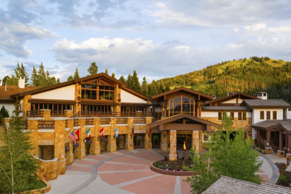 The stone-and-timber facade of Stein Eriksen Lodge at golden hour
