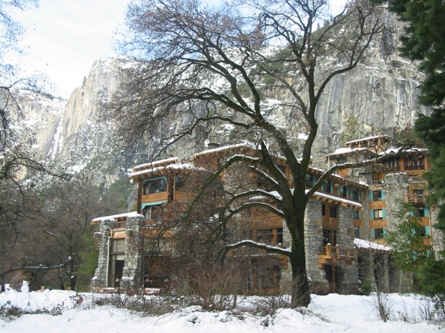 The granite-and-timber facade of the historic 1927 Ahwahnee Hotel in winter snow