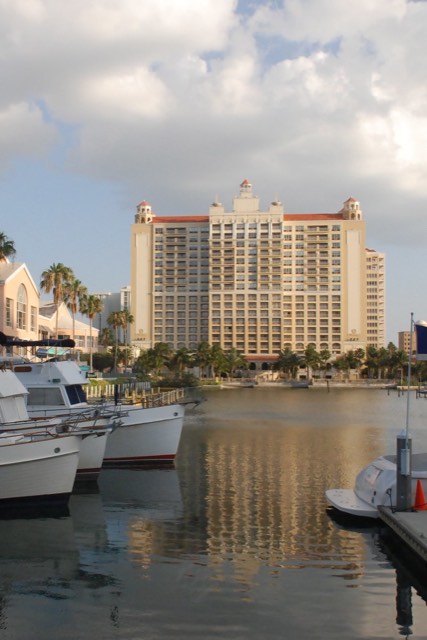 The Ritz-Carlton, Sarasota — its cupola-topped bayfront tower seen across the marina with boats moored in the foreground