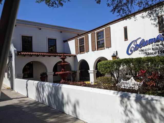 The white stucco exterior and courtyard fountain of the Columbia Restaurant in St. Augustine, with its 'Since 1905' signage