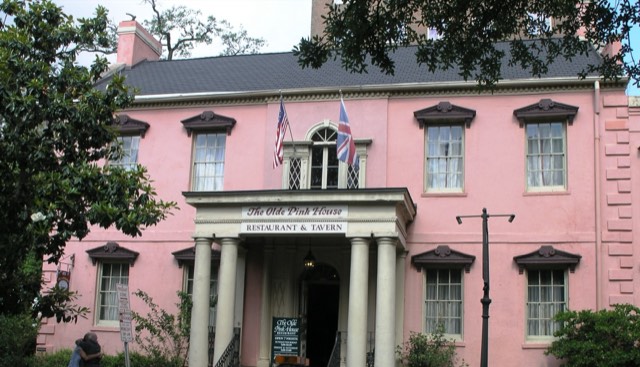 The Olde Pink House — the iconic 1771 pink Georgian mansion with white columns and US and British flags on Reynolds Square, Savannah